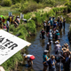Climate activists and Indigenous community members gather on the river for a traditional water ceremony during a rally and march to protest the construction of Enbridge Line 3 pipeline.